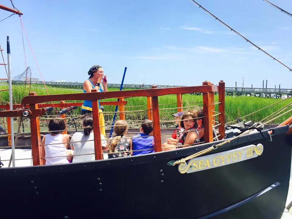 A group of kids listening to the crew member give instructions