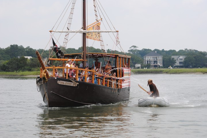 Kids shooting water cannons at a man