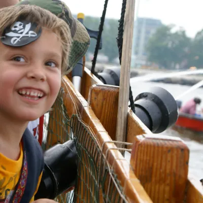 A kid smiling while wearing an eye patch