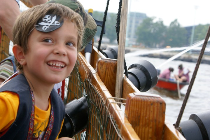 A kid smiling while wearing an eye patch