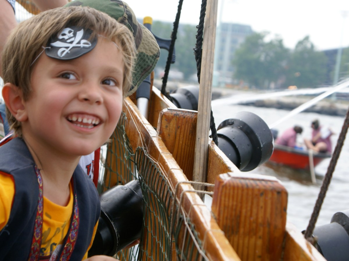 A kid smiling while wearing an eye patch